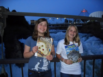 Tess and Meow holding magazines